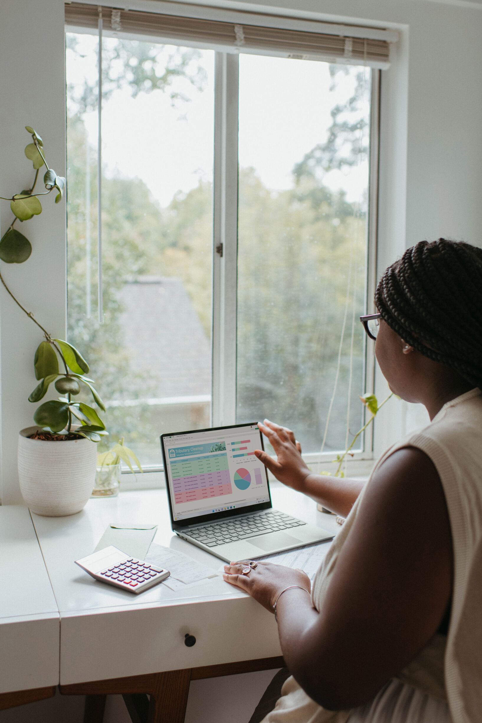 a woman sitting at a table using a laptop