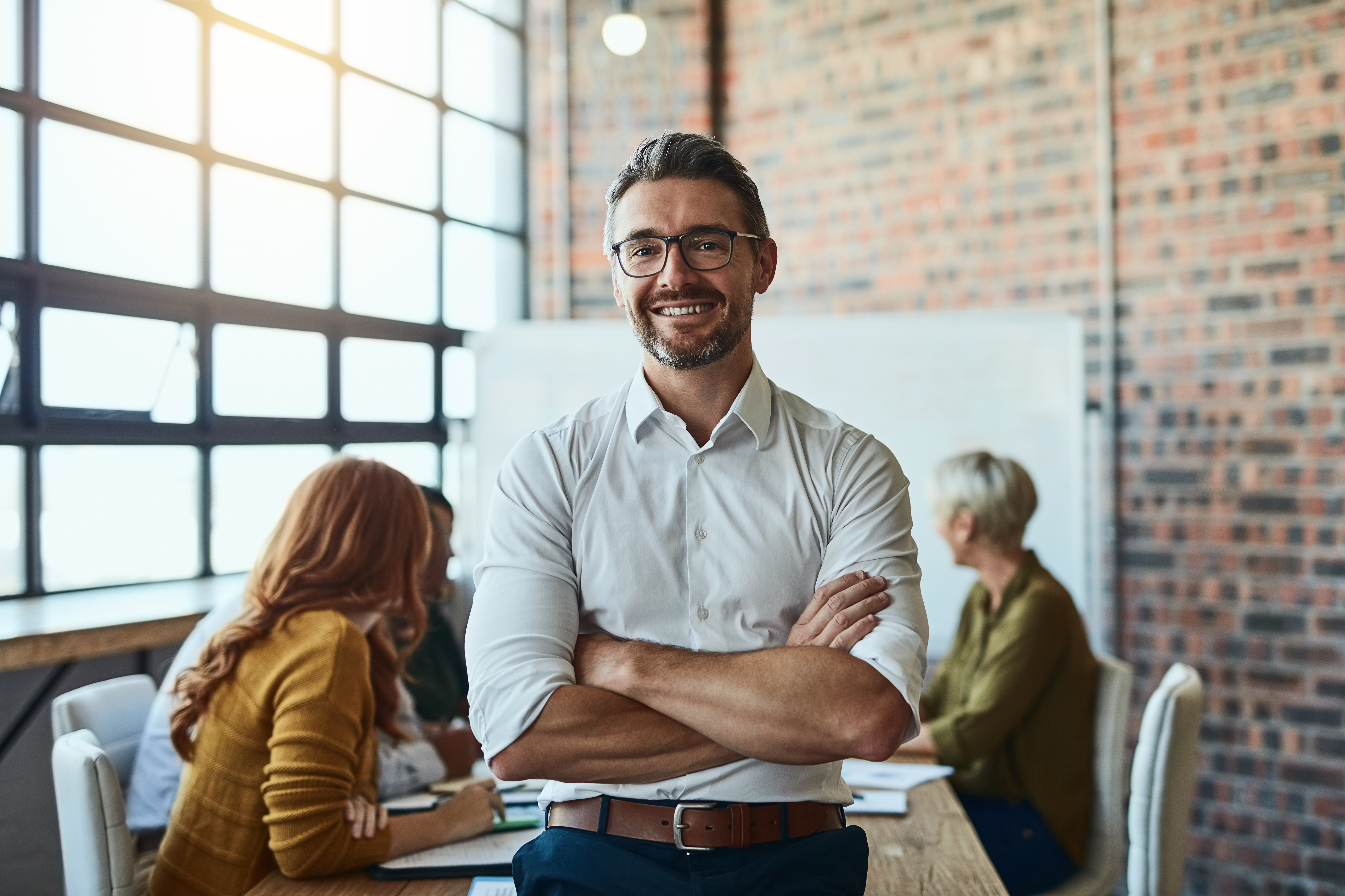 Business man standing in center with folding arms