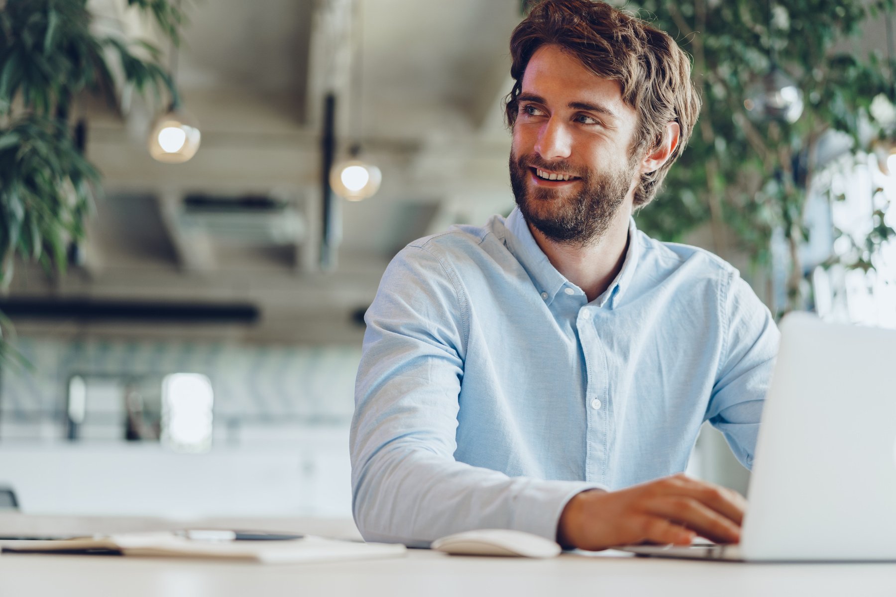 Businessman in shirt working on his laptop