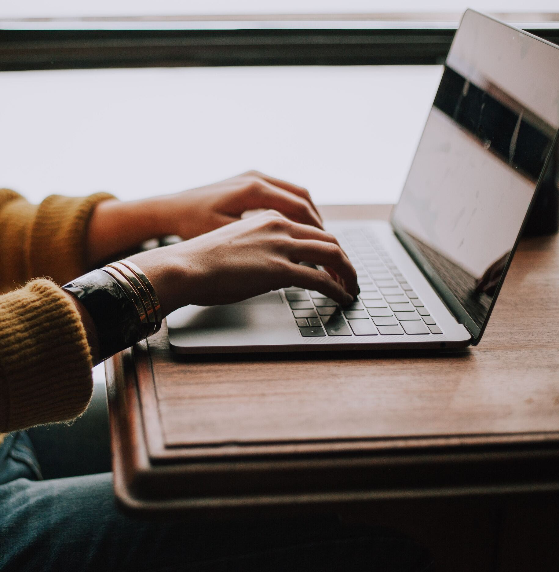 person sitting front of laptop