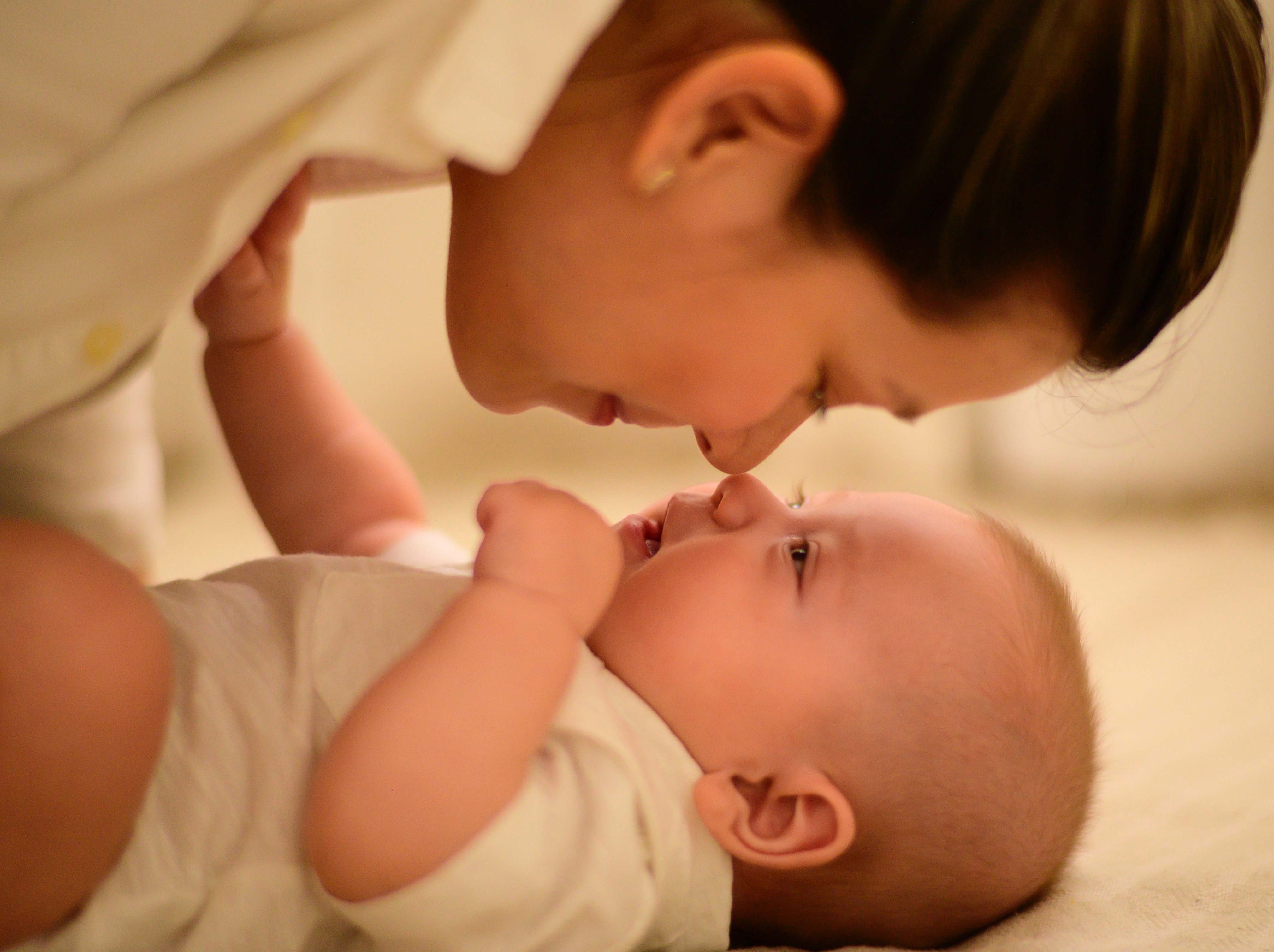 Mother nose to nose kiss with baby